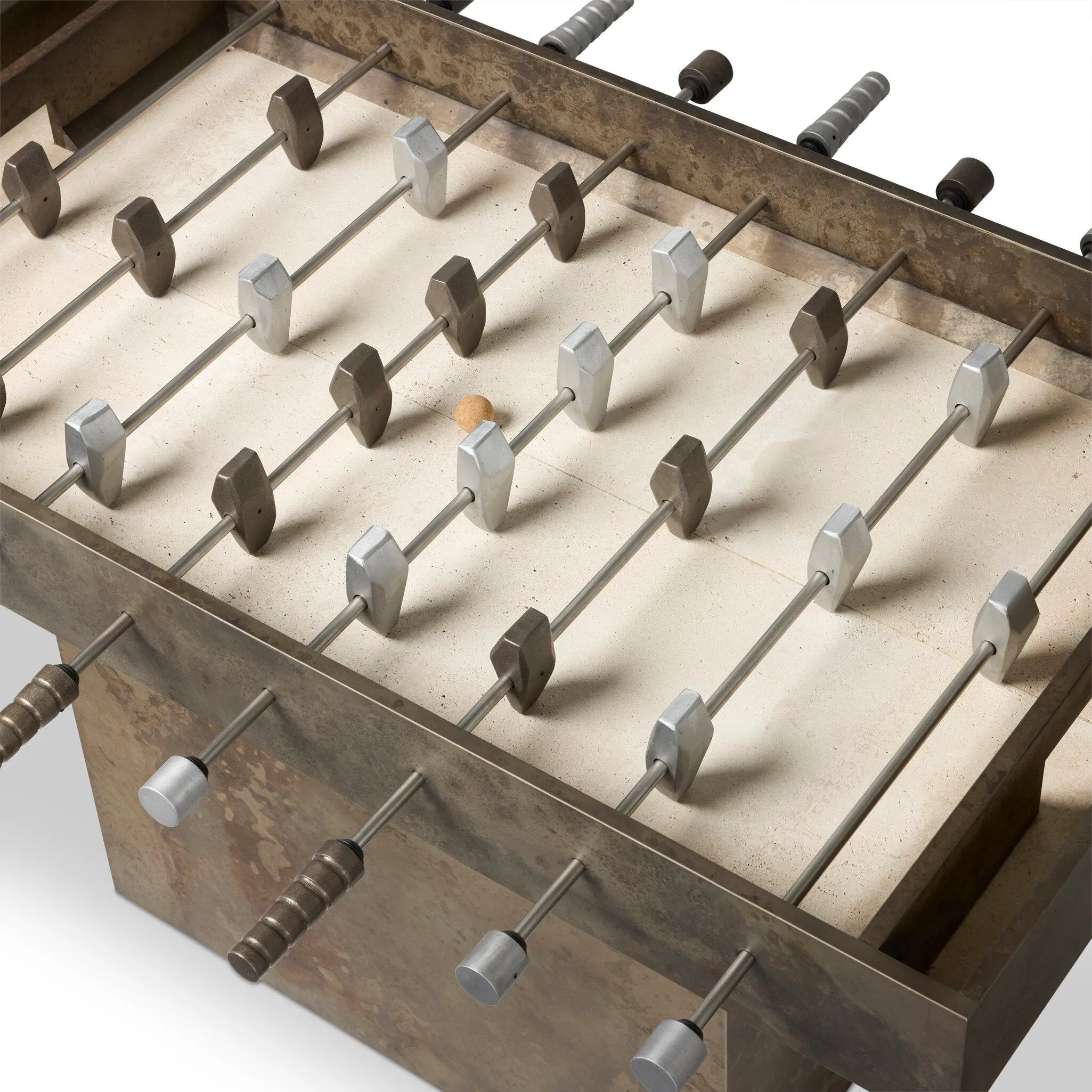 Inspired by Brutalist design, this outdoor foosball table is constructed of industrial oxidized aluminum panels, framing a travertine play surface atop a monolith plinth base that highlights the character of the finish. Two-toned players are cast in solid aluminum. Cover or store indoors during inclement weather and when not in use. Amethyst Home provides interior design, new home construction design consulting, vintage area rugs, and lighting in the Salt Lake City metro area.