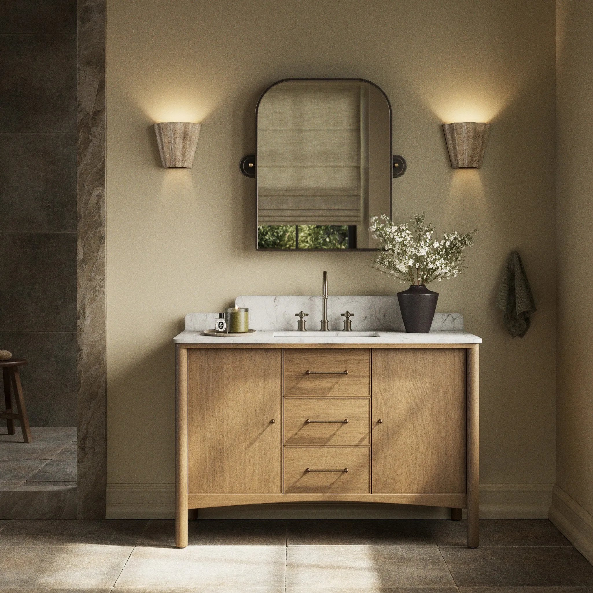 A simple transitional shape designed to function across styles. This bath vanity nods to heritage designs with the softly shaped backsplash, dowel legs, rounded corners and arch frame detail, finished with mixed hardware for added visual interest. Finished with a bath-safe sealant for moisture resistance. Amethyst Home provides interior design, new home construction design consulting, vintage area rugs, and lighting in the Austin metro area.