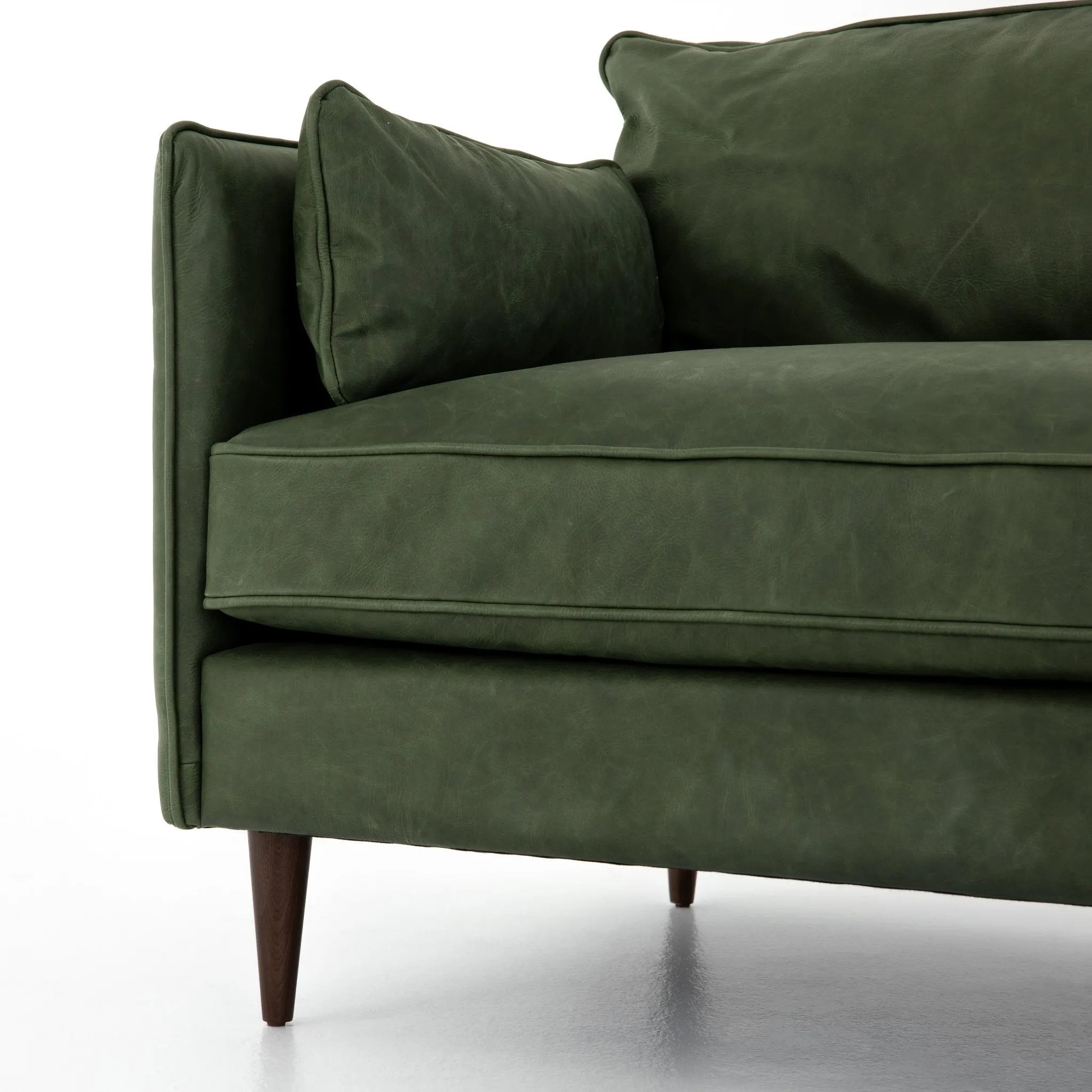 Featuring Reese Eden Sage Sofa by Four Hands at Amethyst Home. Effortlessly on-trend. Two-cushion seating of sage top-grain leather, with knife-edge pillows and welted track arms. Almond-finished legs taper for a modern touch atop mid-century influence.Overall Dimensions: 76.00"w x 35.00"d x 32.75"hWeight : 110.89 lbsMaterials: Top Grain Leather, Poplar Plywood. Amethyst Home provides interior design, new home construction design consulting, vintage area rugs, and lighting in the Tampa metro area.