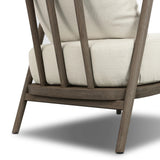 Capturing the ease of tropical ratan seating, an oversized outdoor chair is shaped from FSC-certified teak and wrapped with rush cord detailing. Exemplary woodworking is seen in the fluid lines that end with sturdy spindle legs supporting the comfortable S-spring fixed seat and loose cushion, upholstered in taupe burlap fabric. Amethyst Home provides interior design, new home construction design consulting, vintage area rugs, and lighting in the Austin metro area.