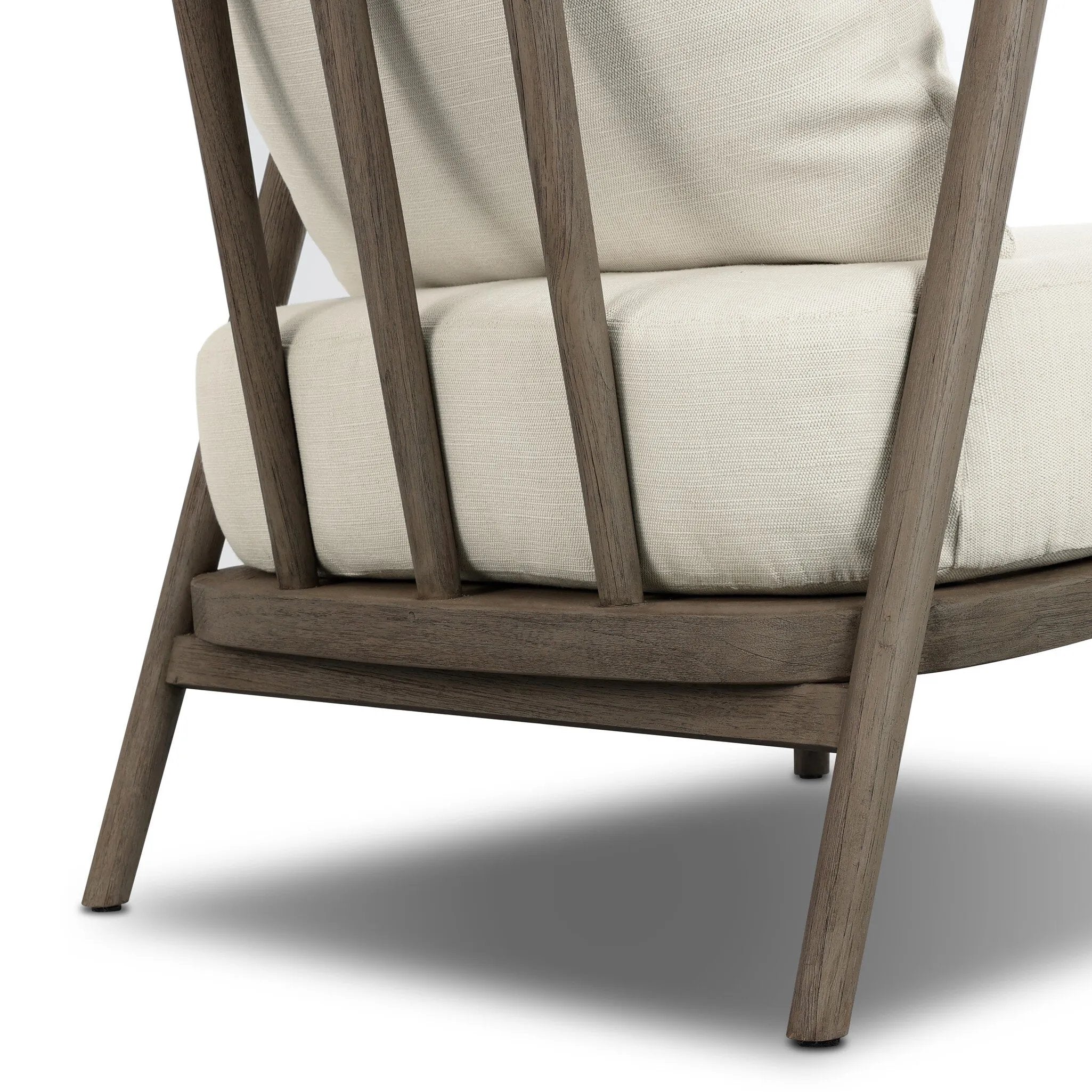 Capturing the ease of tropical ratan seating, an oversized outdoor chair is shaped from FSC-certified teak and wrapped with rush cord detailing. Exemplary woodworking is seen in the fluid lines that end with sturdy spindle legs supporting the comfortable S-spring fixed seat and loose cushion, upholstered in taupe burlap fabric. Amethyst Home provides interior design, new home construction design consulting, vintage area rugs, and lighting in the Austin metro area.