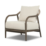 Capturing the ease of tropical ratan seating, an oversized outdoor chair is shaped from FSC-certified teak and wrapped with rush cord detailing. Exemplary woodworking is seen in the fluid lines that end with sturdy spindle legs supporting the comfortable S-spring fixed seat and loose cushion, upholstered in taupe burlap fabric. Amethyst Home provides interior design, new home construction design consulting, vintage area rugs, and lighting in the Kansas City metro area.