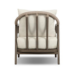 Capturing the ease of tropical ratan seating, an oversized outdoor chair is shaped from FSC-certified teak and wrapped with rush cord detailing. Exemplary woodworking is seen in the fluid lines that end with sturdy spindle legs supporting the comfortable S-spring fixed seat and loose cushion, upholstered in taupe burlap fabric. Amethyst Home provides interior design, new home construction design consulting, vintage area rugs, and lighting in the Los Angeles metro area.