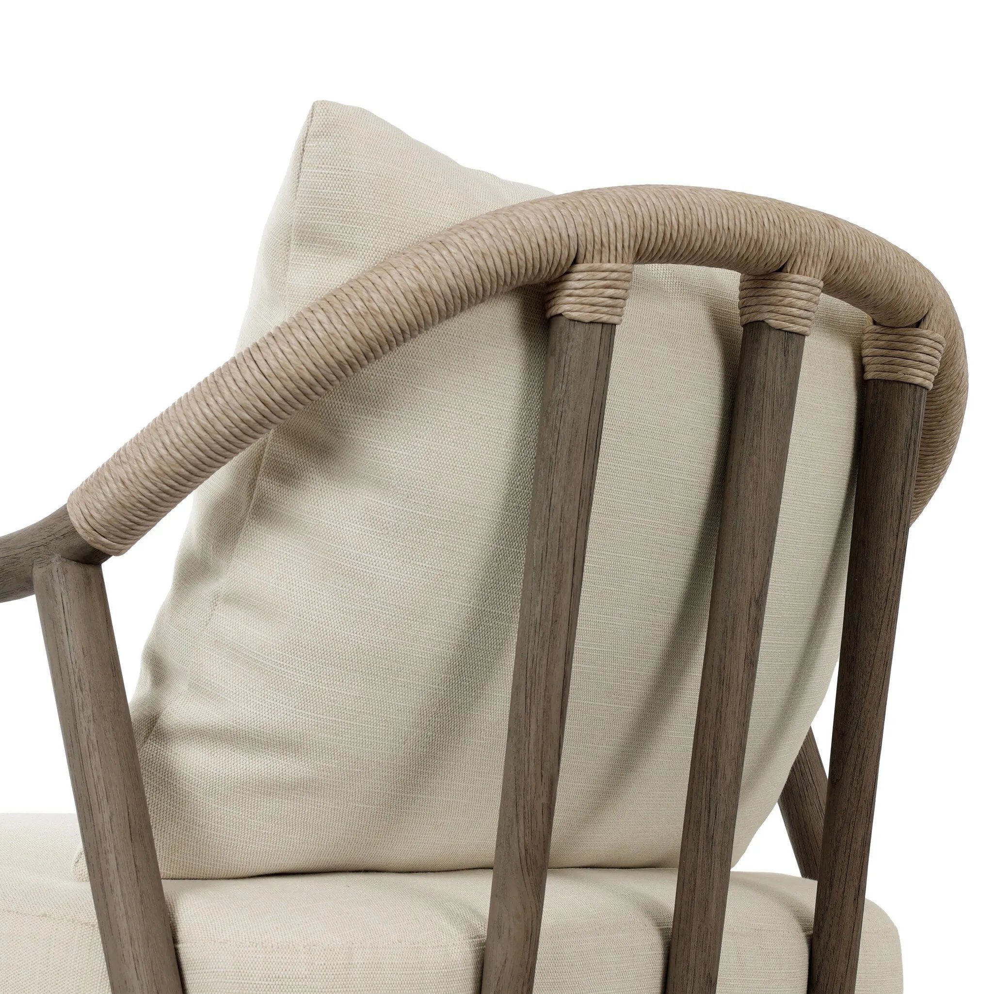 Capturing the ease of tropical ratan seating, an oversized outdoor chair is shaped from FSC-certified teak and wrapped with rush cord detailing. Exemplary woodworking is seen in the fluid lines that end with sturdy spindle legs supporting the comfortable S-spring fixed seat and loose cushion, upholstered in taupe burlap fabric. Amethyst Home provides interior design, new home construction design consulting, vintage area rugs, and lighting in the Monterey metro area.