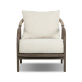Capturing the ease of tropical ratan seating, an oversized outdoor chair is shaped from FSC-certified teak and wrapped with rush cord detailing. Exemplary woodworking is seen in the fluid lines that end with sturdy spindle legs supporting the comfortable S-spring fixed seat and loose cushion, upholstered in taupe burlap fabric. Amethyst Home provides interior design, new home construction design consulting, vintage area rugs, and lighting in the Newport Beach metro area.