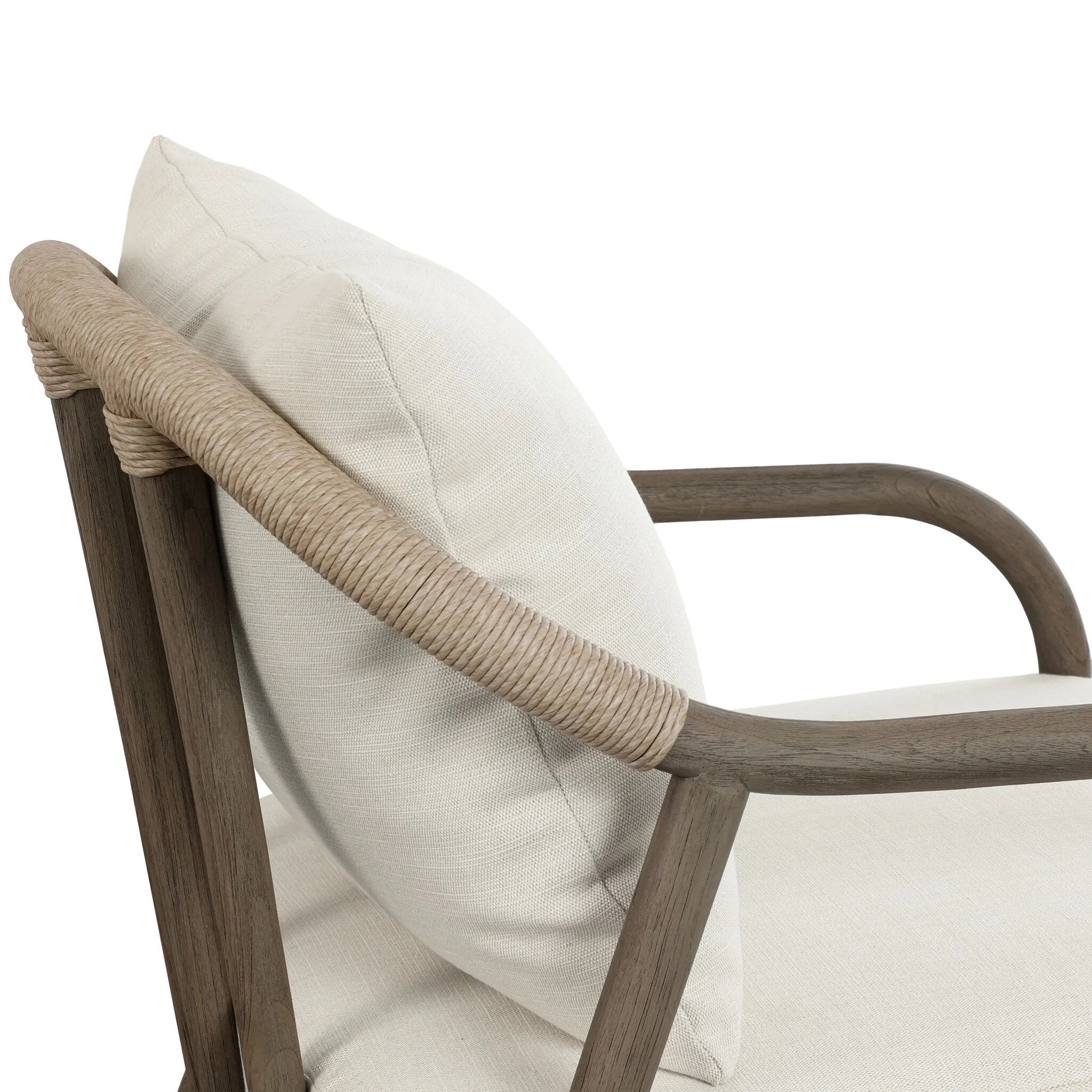 Capturing the ease of tropical ratan seating, an oversized outdoor chair is shaped from FSC-certified teak and wrapped with rush cord detailing. Exemplary woodworking is seen in the fluid lines that end with sturdy spindle legs supporting the comfortable S-spring fixed seat and loose cushion, upholstered in taupe burlap fabric. Amethyst Home provides interior design, new home construction design consulting, vintage area rugs, and lighting in the Park City metro area.