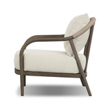 Capturing the ease of tropical ratan seating, an oversized outdoor chair is shaped from FSC-certified teak and wrapped with rush cord detailing. Exemplary woodworking is seen in the fluid lines that end with sturdy spindle legs supporting the comfortable S-spring fixed seat and loose cushion, upholstered in taupe burlap fabric. Amethyst Home provides interior design, new home construction design consulting, vintage area rugs, and lighting in the San Diego metro area.