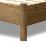 Rounded, chunky dowel legs in an amber oak finish frame the tan top-grain leather headboard of this simple-but-striking bed frame Amethyst Home provides interior design, new home construction design consulting, vintage area rugs, and lighting in the Kansas City metro area.