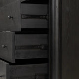 Create storage space in the bedroom with a five-drawer dresser of ebony-finished oak. Chunky dowel legs support a tall silhouette and overhang top, all finished out with simple gunmetal hardware Amethyst Home provides interior design, new home construction design consulting, vintage area rugs, and lighting in the Calabasas metro area.