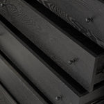 Create storage space in the bedroom with a five-drawer dresser of ebony-finished oak. Chunky dowel legs support a tall silhouette and overhang top, all finished out with simple gunmetal hardware Amethyst Home provides interior design, new home construction design consulting, vintage area rugs, and lighting in the San Diego metro area.