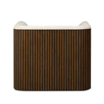 Designed with a shelter-style silhouette, this swivel chair wraps around for a seamless sit. The showstopping wood fluting adds textural contrast and organic appeal to the 360-degree swivel.As fans of clean aesthetics at Amethyst, we love the nature inspired Rory Swivel Chair - Laughlin Bone. Amethyst Home provides interior design, new home construction design consulting, vintage area rugs, and lighting in the Boston metro area.