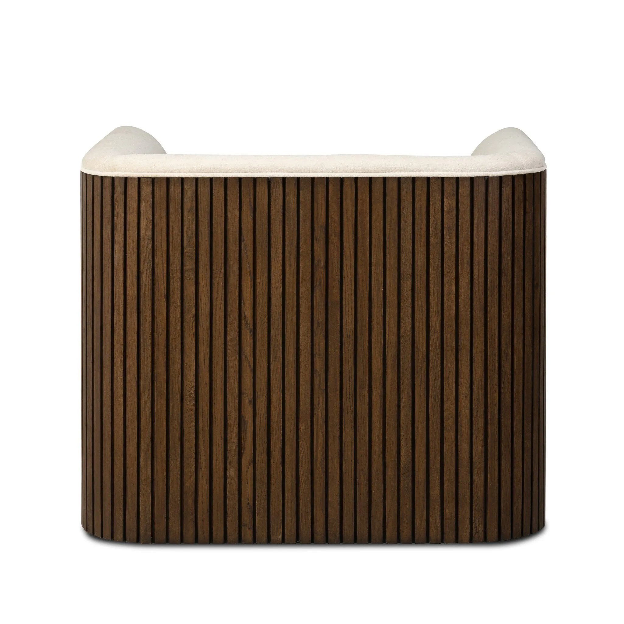 Designed with a shelter-style silhouette, this swivel chair wraps around for a seamless sit. The showstopping wood fluting adds textural contrast and organic appeal to the 360-degree swivel.As fans of clean aesthetics at Amethyst, we love the nature inspired Rory Swivel Chair - Laughlin Bone. Amethyst Home provides interior design, new home construction design consulting, vintage area rugs, and lighting in the Boston metro area.