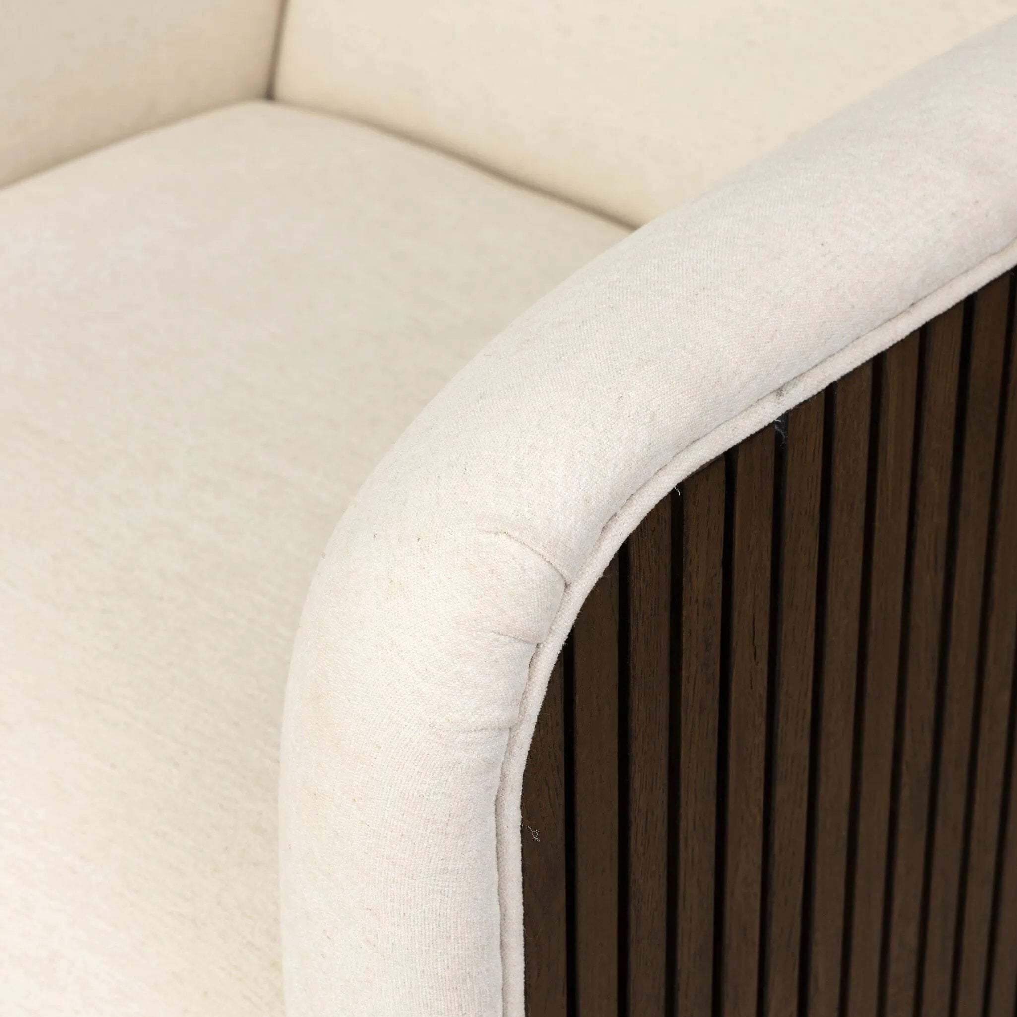 Designed with a shelter-style silhouette, this swivel chair wraps around for a seamless sit. The showstopping wood fluting adds textural contrast and organic appeal to the 360-degree swivel.As fans of clean aesthetics at Amethyst, we love the nature inspired Rory Swivel Chair - Laughlin Bone. Amethyst Home provides interior design, new home construction design consulting, vintage area rugs, and lighting in the Kansas City metro area.