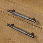 Amber-finished oak crafts shapes a clean silhouette, accented with iron hardware wrapped in black top-grain leather. Vary-sized drawers offer plenty of storage, while outset legs bring a design-forward touch Amethyst Home provides interior design, new home construction design consulting, vintage area rugs, and lighting in the Kansas City metro area.