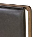 Amber-finished solid oak frames a floating, sling-style headboard made from black top-grain leather, with subtly rounded edges and metal dowel detailing Amethyst Home provides interior design, new home construction design consulting, vintage area rugs, and lighting in the Alpharetta metro area.