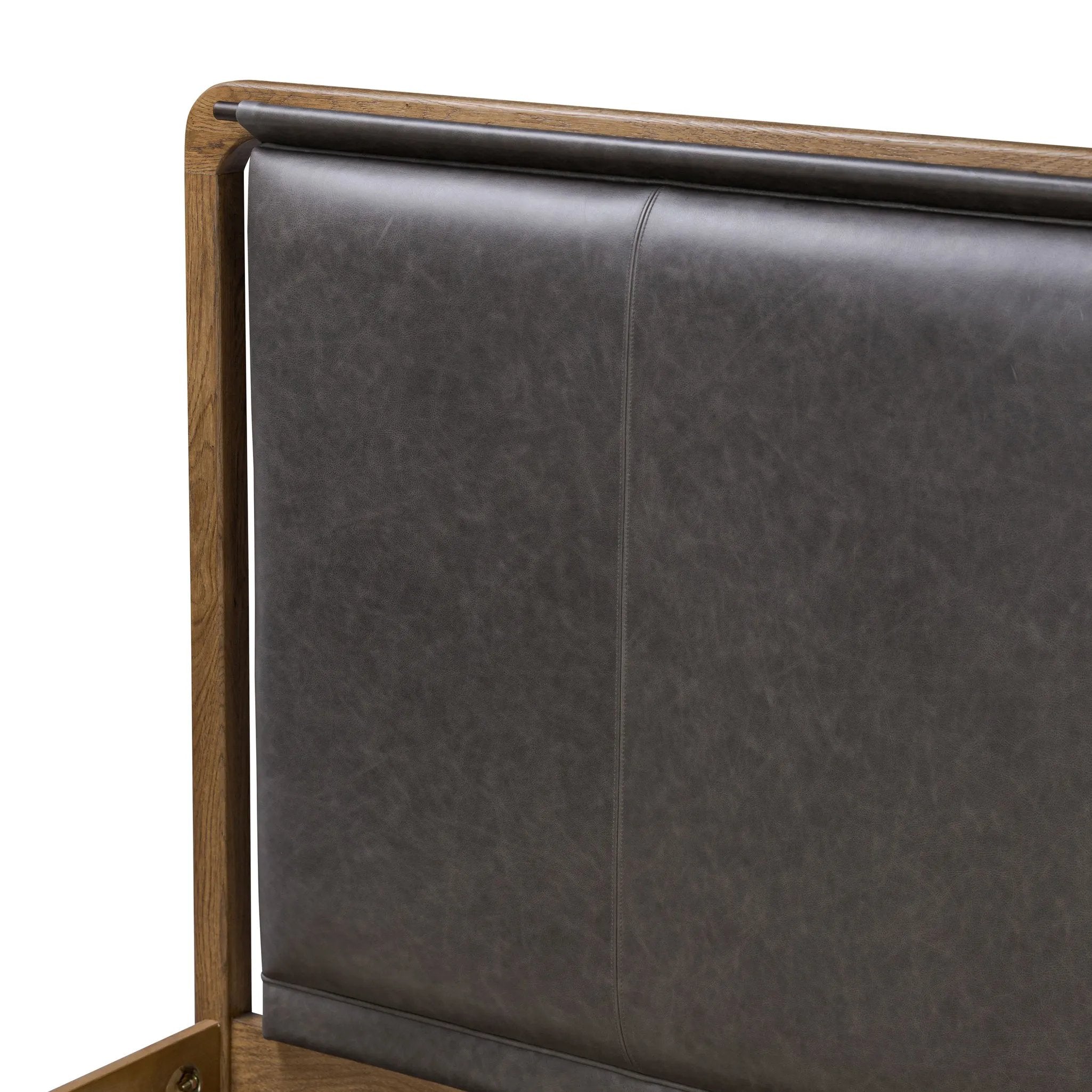 Amber-finished solid oak frames a floating, sling-style headboard made from black top-grain leather, with subtly rounded edges and metal dowel detailing Amethyst Home provides interior design, new home construction design consulting, vintage area rugs, and lighting in the Laguna Beach metro area.