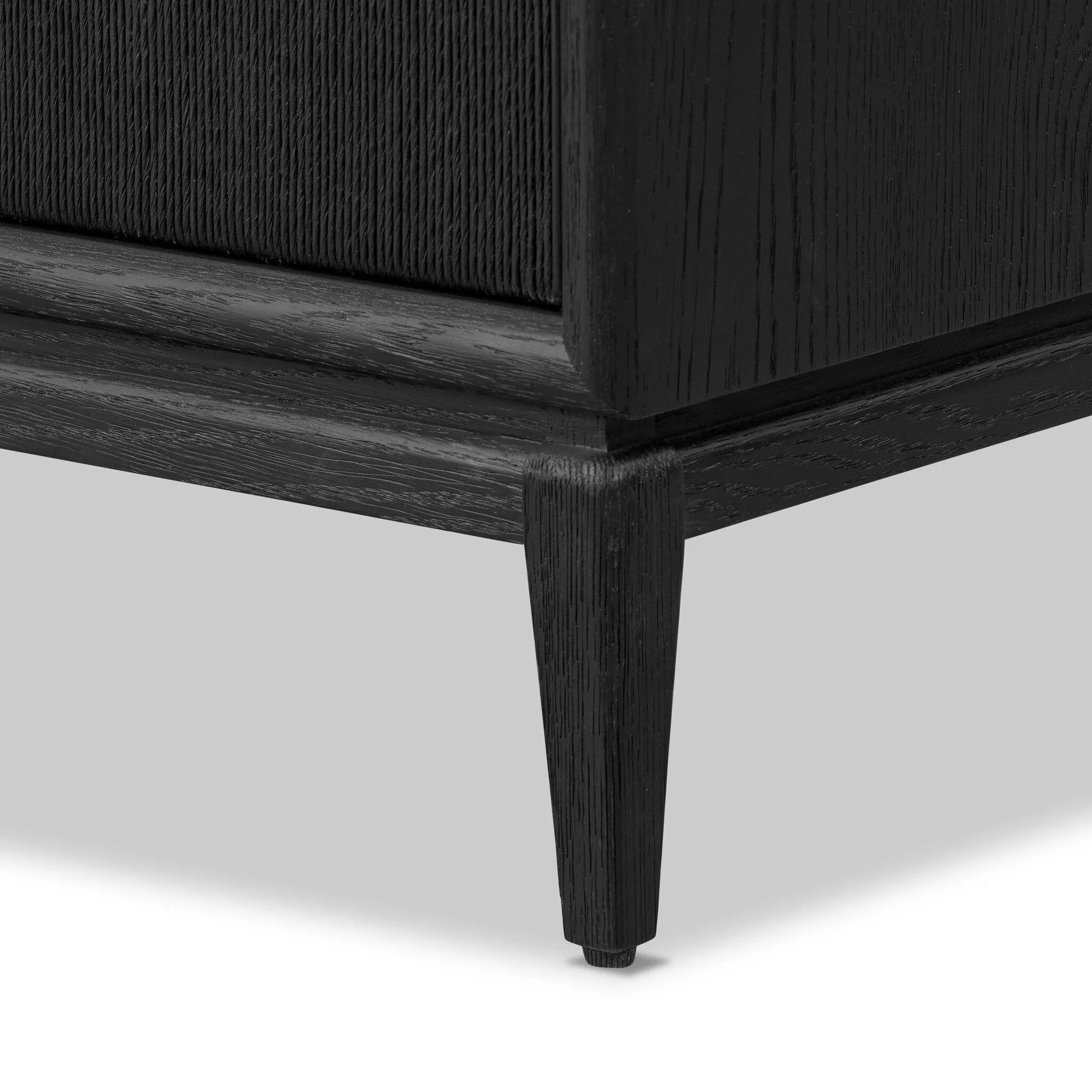 Elevate your bedroom styling with a storage-driven dresser of black-finished oak. A smooth top pairs with eight spacious drawers covered with woven paper cord. The result: a dark, Scandinavian-inspired look that will work into your collection beautifully Amethyst Home provides interior design, new home construction design consulting, vintage area rugs, and lighting in the Los Angeles metro area.