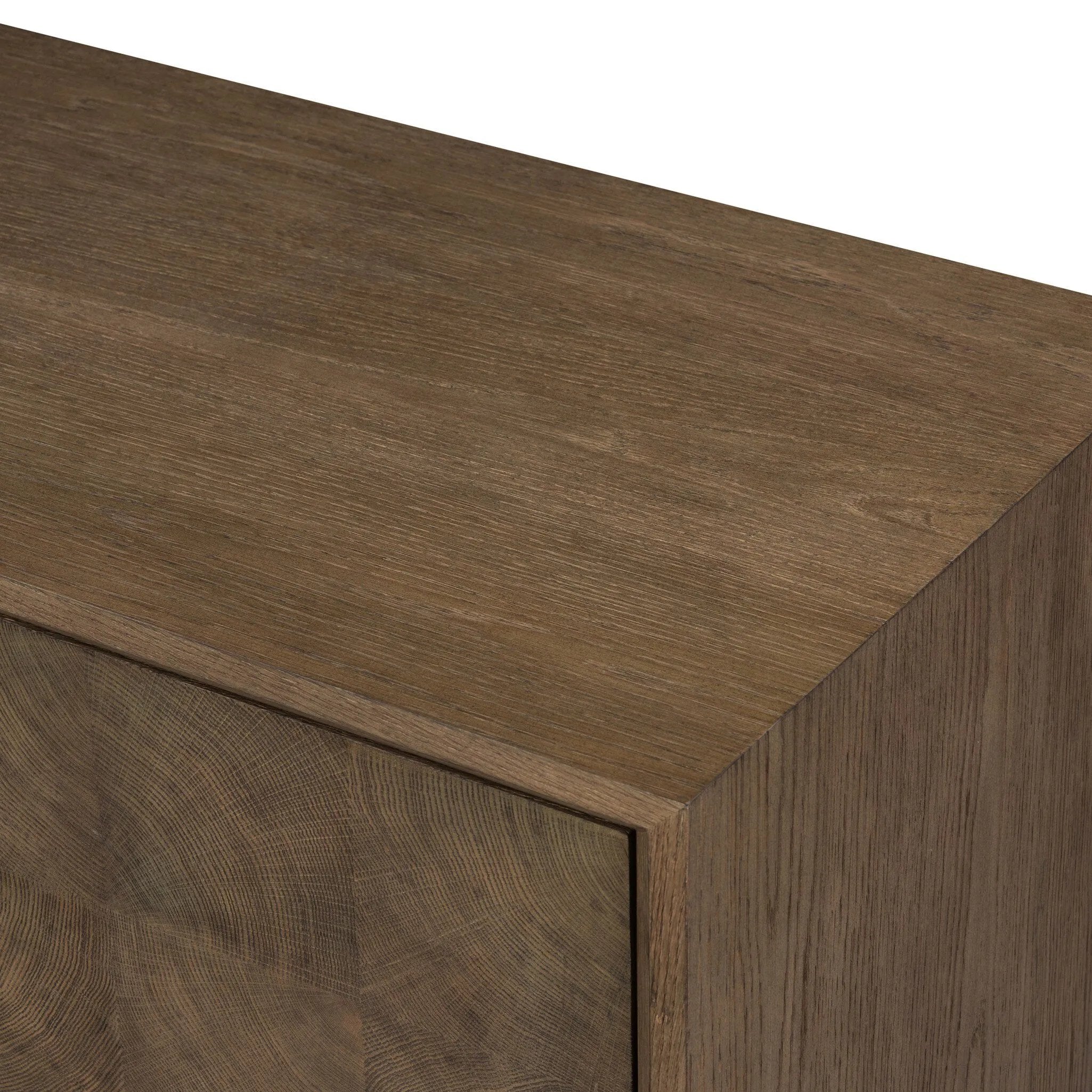 Grounding and stunning. We paired a modern frame and chunky base with door panels featuring oyster cuts of oak that take a specialized skill to create. Each cut captures the story of the wood and brings a natural, organic rhythm to the entire sideboard, and any space. Amethyst Home provides interior design, new home construction design consulting, vintage area rugs, and lighting in the Charlotte metro area.