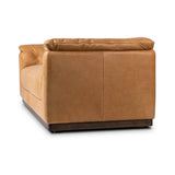 Inspired by 1970s Brutalism, this urban tuxedo sofa balances a rounded solid wood plinth with a curved seat deck and a relaxed, "wrinkled" upholstery design. Feather-blend cushions wrap the frame, finished with dramatic blind tufting for a hand-crafted, textural edge. Amethyst Home provides interior design, new home construction design consulting, vintage area rugs, and lighting in the Calabasas metro area.