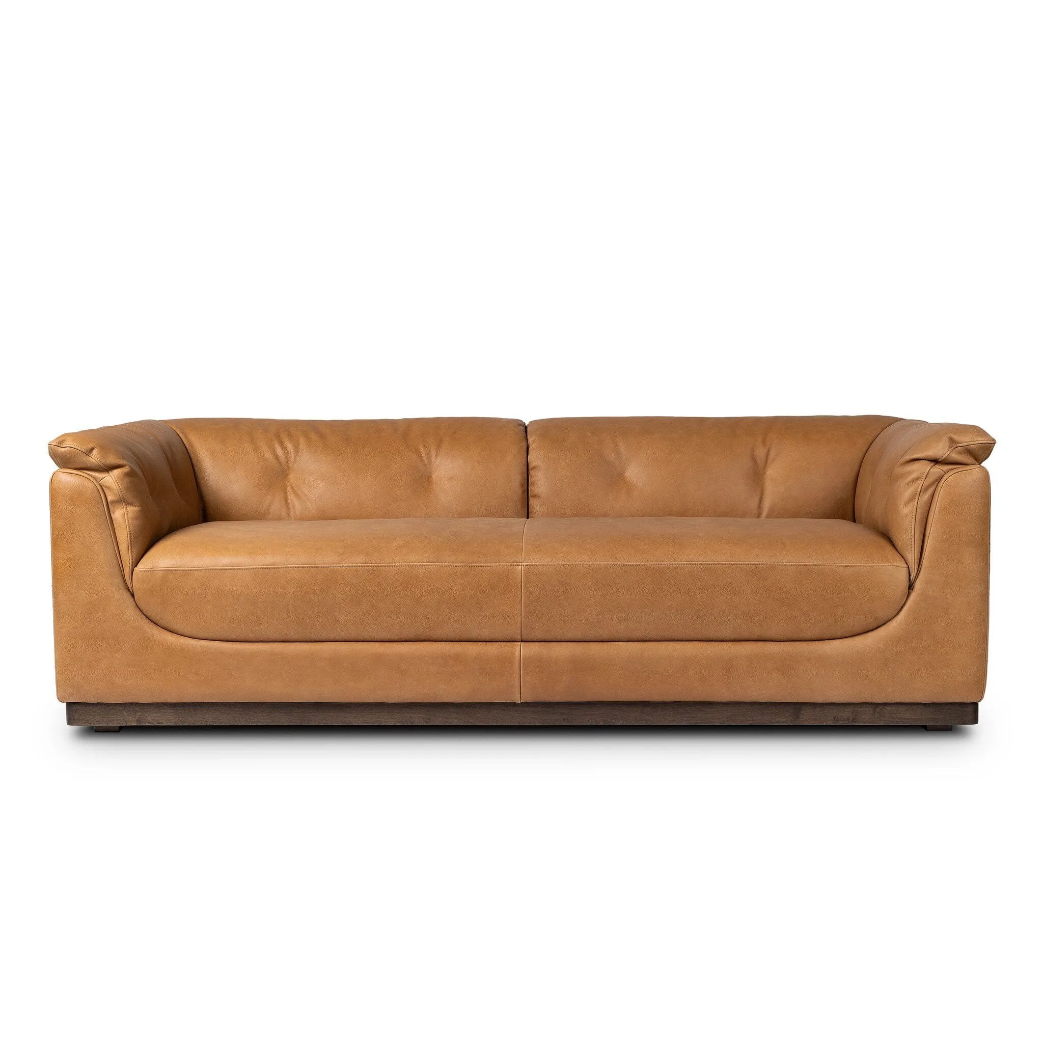 Inspired by 1970s Brutalism, this urban tuxedo sofa balances a rounded solid wood plinth with a curved seat deck and a relaxed, "wrinkled" upholstery design. Feather-blend cushions wrap the frame, finished with dramatic blind tufting for a hand-crafted, textural edge. Amethyst Home provides interior design, new home construction design consulting, vintage area rugs, and lighting in the Houston metro area.
