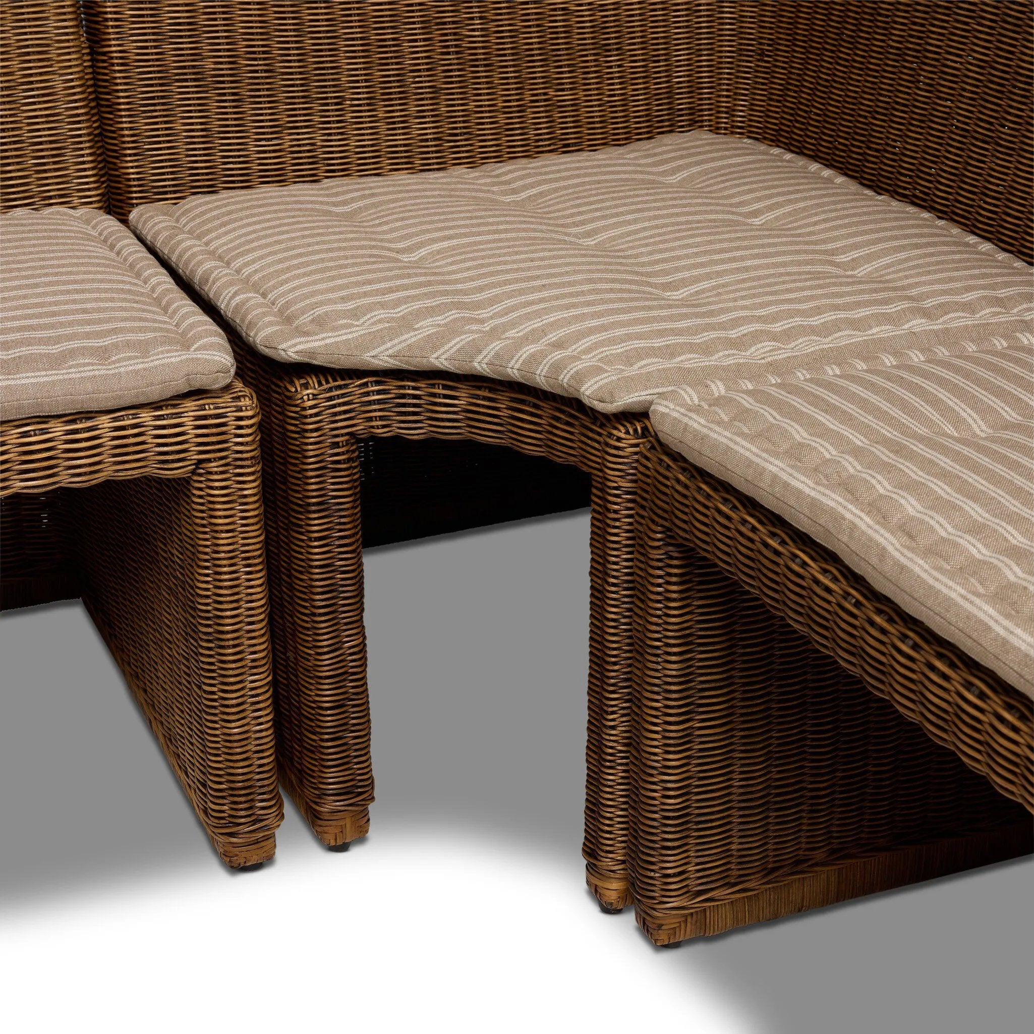 Antique-inspired coastal style. Rattan introduces varying natural shades and texture to this dining bench, and the frame's soft lines and beige and white striped fabric cushion invite a comfortable sit. Option to style alone or pair with other pieces in the collection. A design collaboration by Amber Lewis and Four Hands. Amethyst Home provides interior design, new home construction design consulting, vintage area rugs, and lighting in the Charlotte metro area.