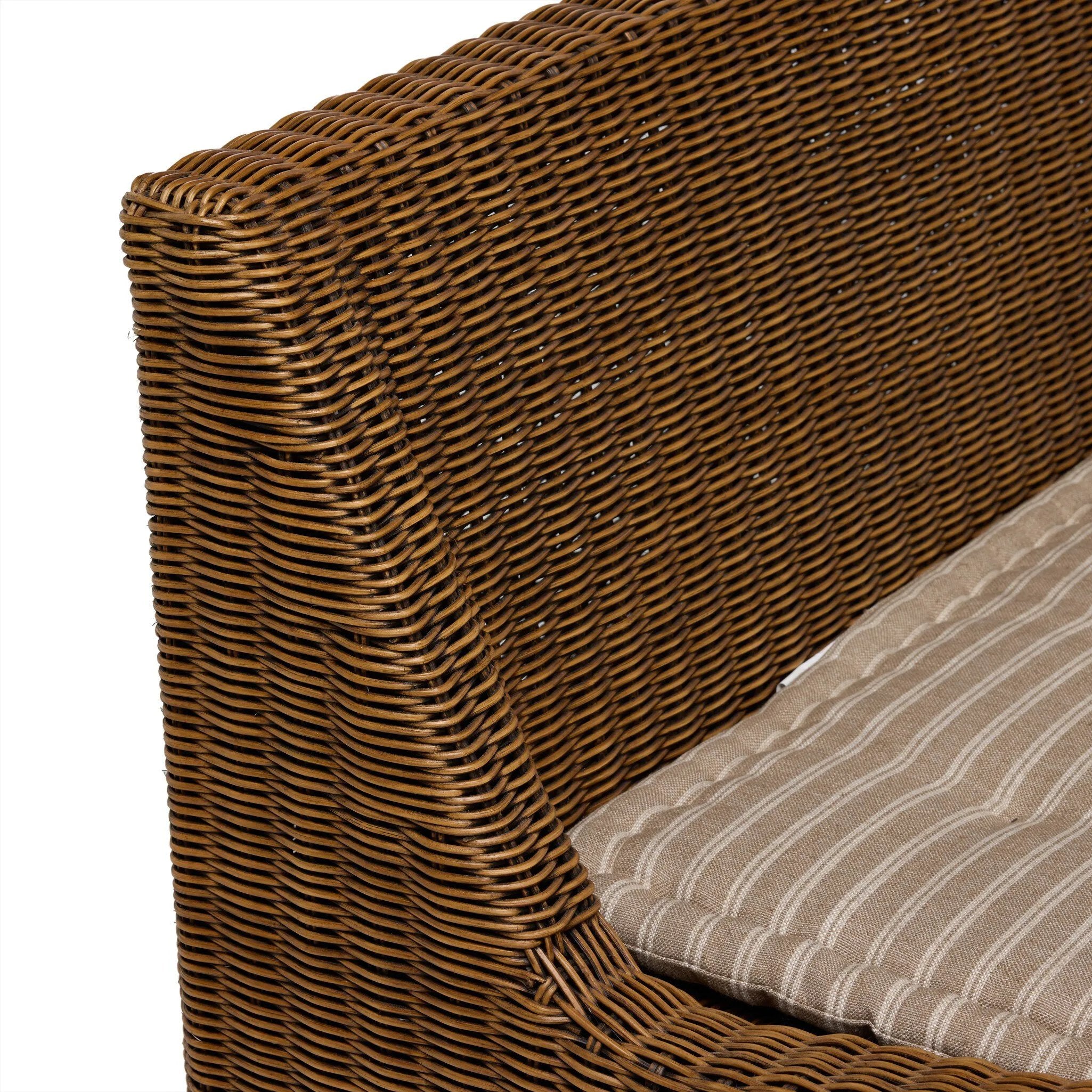 Antique-inspired coastal style. Rattan introduces varying natural shades and texture to this dining bench, and the frame's soft lines and beige and white striped fabric cushion invite a comfortable sit. Option to style alone or pair with other pieces in the collection. A design collaboration by Amber Lewis and Four Hands. Amethyst Home provides interior design, new home construction design consulting, vintage area rugs, and lighting in the Nashville metro area.