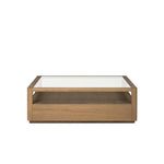 Bring bonus storage and a light look to the living space. Made from sandy oak and clear tempered glass with two roomy drawers on either side of the base, plus shelving beneath the glass that doubles as a shadowbox or an extra display surface.As lovers of luxe design at Amethyst, we love the warm modern inspired Shiloh Coffee Table - Tempered Glass. Amethyst Home provides interior design, new home construction design consulting, vintage area rugs, and lighting in the Houston metro area.