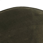 Upholstered in a deep olive velvet and paired with a rich brown base, this rounded ottoman can be placed just about anywhere.