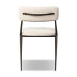 Bring a slim, light look to the dining room. This dining chair pairs cream performance fabric exclusive to Four Hands and bronzed iron to craft a simple, airy look. A tapered leg and decorative handle on the back elevate the look. Amethyst Home provides interior design, new home construction design consulting, vintage area rugs, and lighting in the Boston metro area.