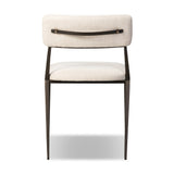 Bring a slim, light look to the dining room. This dining chair pairs cream performance fabric exclusive to Four Hands and bronzed iron to craft a simple, airy look. A tapered leg and decorative handle on the back elevate the look. Amethyst Home provides interior design, new home construction design consulting, vintage area rugs, and lighting in the Boston metro area.