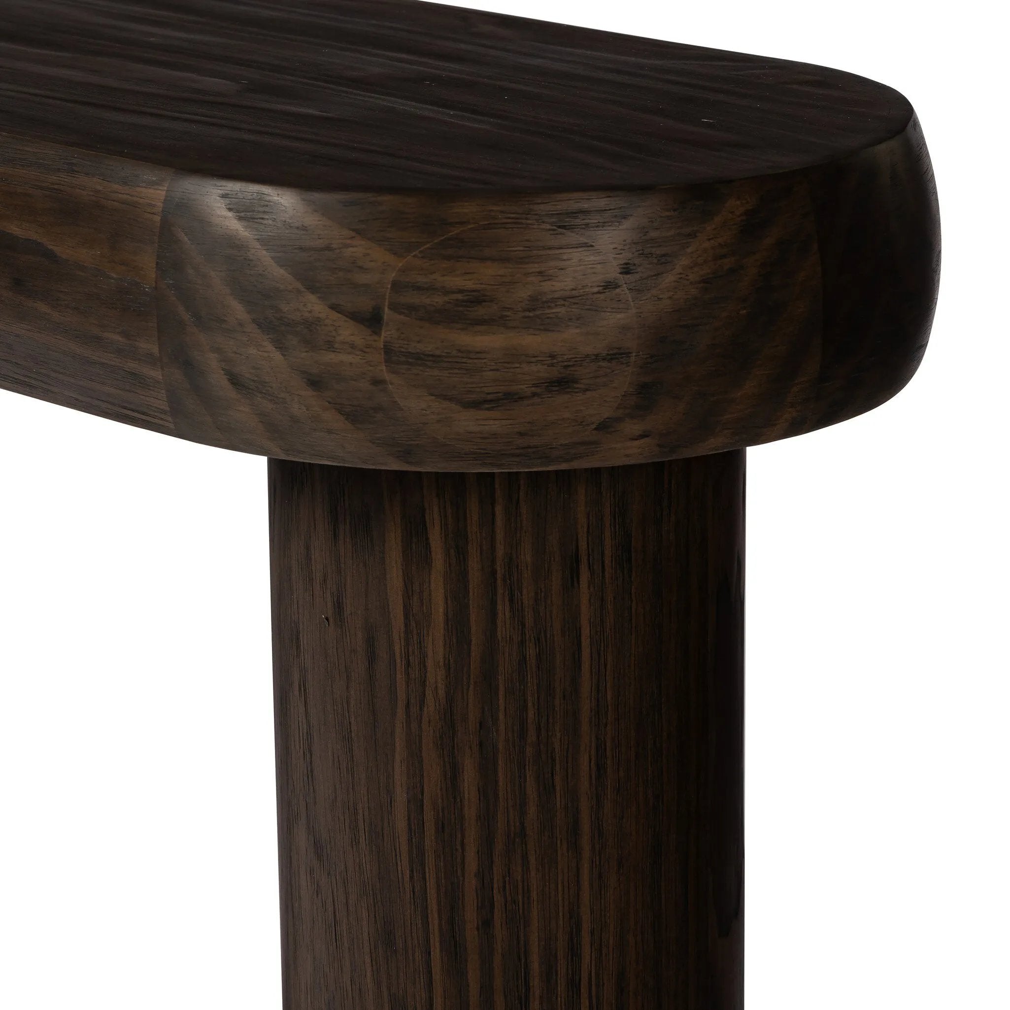 Three round pillar legs support a thick oval top featuring rounded edges. A dark brown pine finish showcases rich grain movement, playing up the curvature of this piece.Collection: Westgat Amethyst Home provides interior design, new home construction design consulting, vintage area rugs, and lighting in the Dallas metro area.