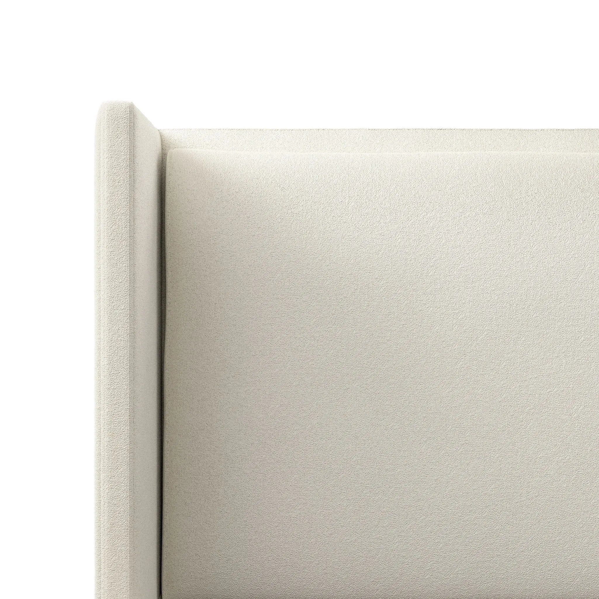 A shorter wingspan and geometric cutouts define this modern-day shelter wingback bed, designed for comfort from every angle. Upholstered in a cream fabric with subtle texture and a soft hand Amethyst Home provides interior design, new home construction design consulting, vintage area rugs, and lighting in the Seattle metro area.