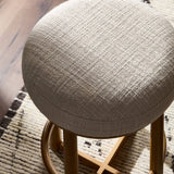 Featuring Staria Saxon Sand Swivel Stool by Four Hands at Amethyst Home. Perfectly sized for the counter, a 360-degree swivel stool pairs a warm oak frame with sand seating in a chunky basketweave. Tapered legs meet a crossed base ties it all together. Overall Dimensions: 18.25"w x 18.25"d x 27.50"h. Amethyst Home provides interior design, new home construction design consulting, vintage area rugs, and lighting in the Houston metro area.