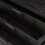 A softened Brutalist take on the traditional nightstand. The monolithic piece’s black oak veneer case sits atop a matching pedestal for an element of exaggeration. A grid pattern with inflated volume adds drama.As enthusiasts of luxe materials at Amethyst, we love the warm modern inspired Swell Nightstand - Dry Black Oak Veneer. Amethyst Home provides interior design, new home construction design consulting, vintage area rugs, and lighting in the Charlotte metro area.