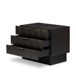 A softened Brutalist take on the traditional nightstand. The monolithic piece’s black oak veneer case sits atop a matching pedestal for an element of exaggeration. A grid pattern with inflated volume adds drama.As enthusiasts of luxe materials at Amethyst, we love the warm modern inspired Swell Nightstand - Dry Black Oak Veneer. Amethyst Home provides interior design, new home construction design consulting, vintage area rugs, and lighting in the Nashville metro area.
