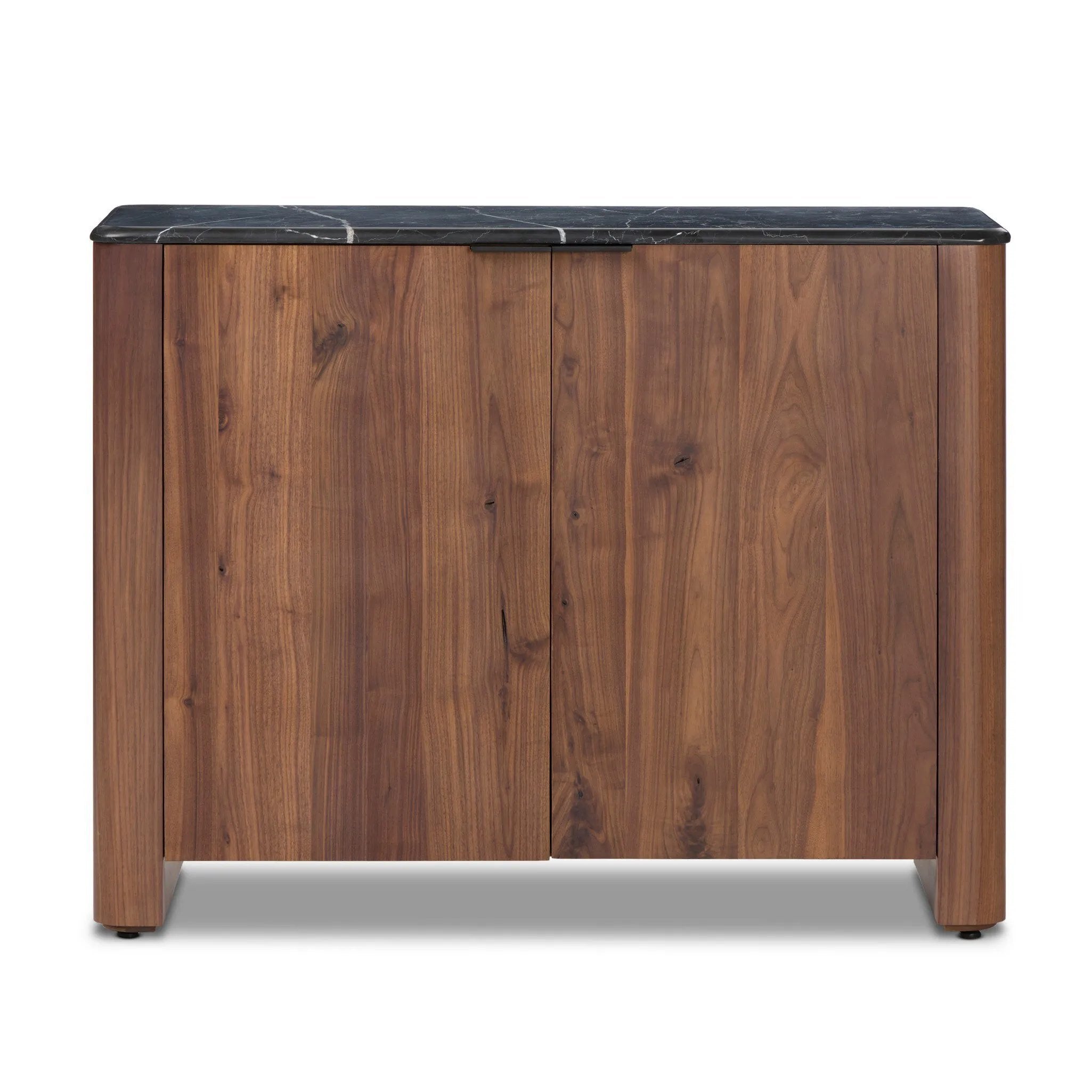 Design your space with hallmark features inspired by soft Brutalism. Made from solid walnut and poplar woods with a natural finish, the cabinet is topped with a black marble top with half bullnose edging for smooth contours. Double doors open to two shelves for ample storage. High-quality hardware is crafted from black iron. Amethyst Home provides interior design, new home construction design consulting, vintage area rugs, and lighting in the Kansas City metro area.