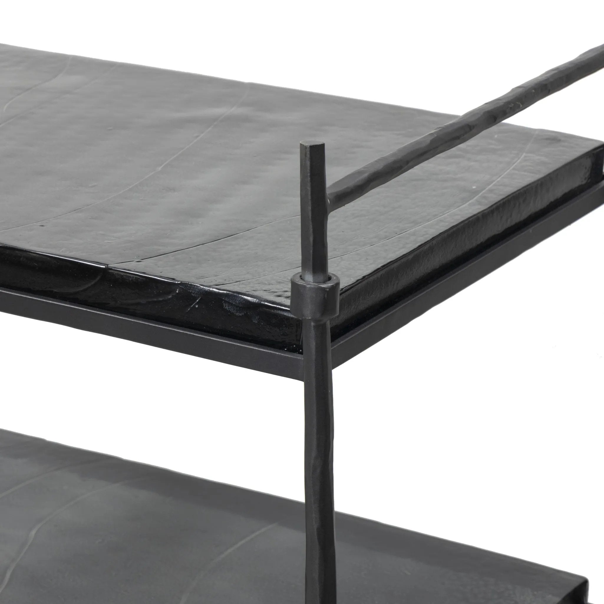 Elevate cocktail hour with an always-in-style rolling bar cart. Crafted from black hammered metal with three tiers of smoked cast glass, offering smooth surface space for storage and display Amethyst Home provides interior design, new home construction design consulting, vintage area rugs, and lighting in the Houston metro area.