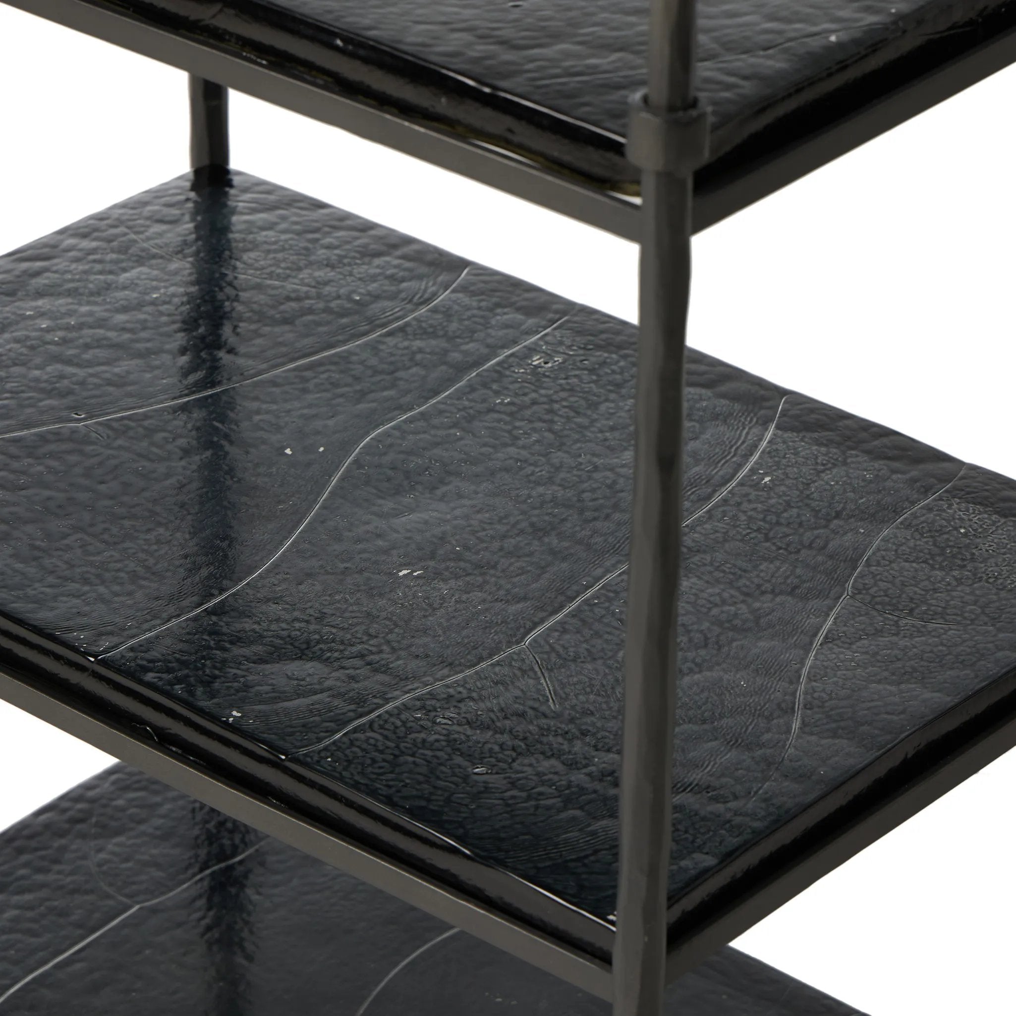 Elevate cocktail hour with an always-in-style rolling bar cart. Crafted from black hammered metal with three tiers of smoked cast glass, offering smooth surface space for storage and display Amethyst Home provides interior design, new home construction design consulting, vintage area rugs, and lighting in the Kansas City metro area.