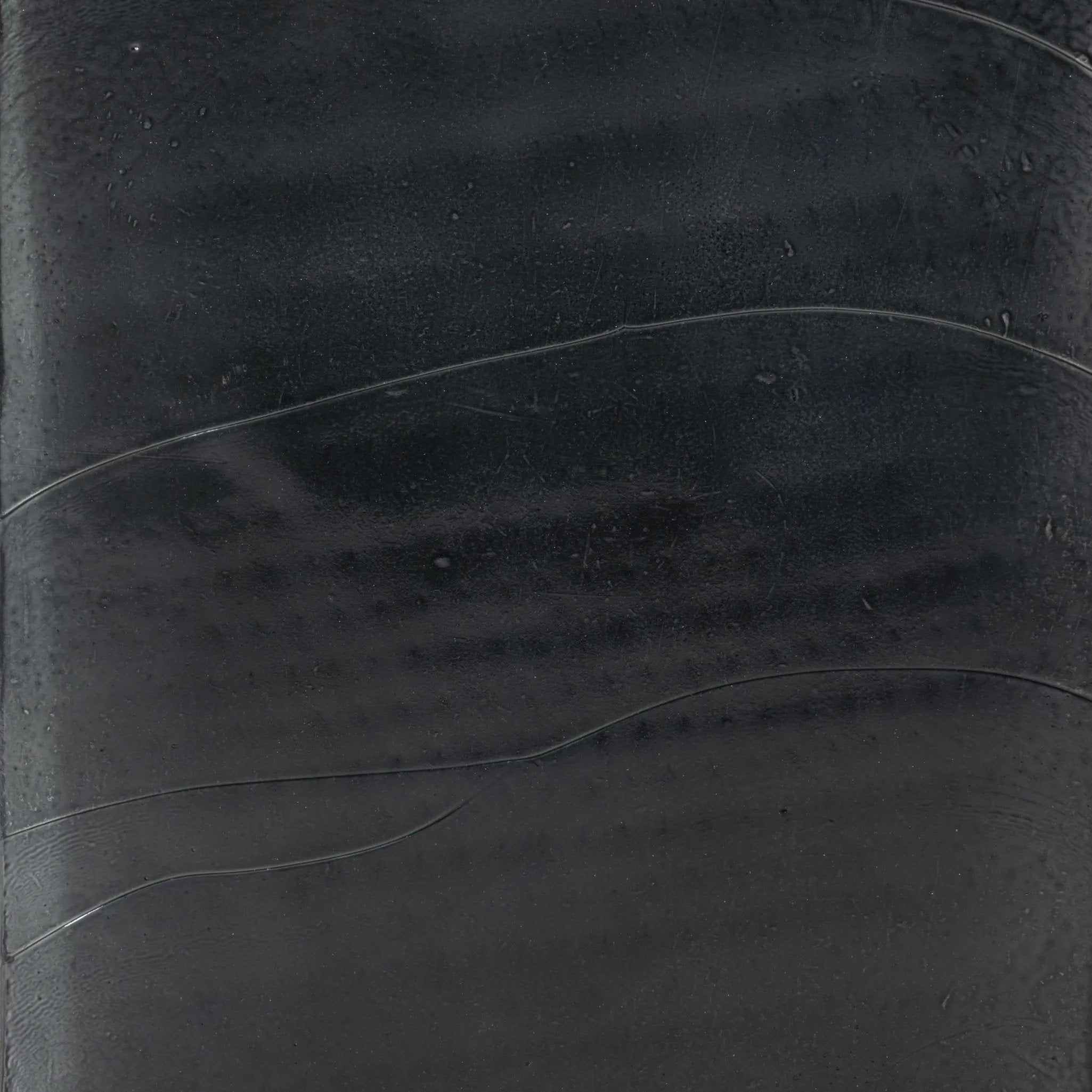 Elevate cocktail hour with an always-in-style rolling bar cart. Crafted from black hammered metal with three tiers of smoked cast glass, offering smooth surface space for storage and display Amethyst Home provides interior design, new home construction design consulting, vintage area rugs, and lighting in the Miami metro area.