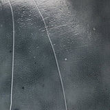 Elevate cocktail hour with an always-in-style rolling bar cart. Crafted from black hammered metal with three tiers of smoked cast glass, offering smooth surface space for storage and display Amethyst Home provides interior design, new home construction design consulting, vintage area rugs, and lighting in the Omaha metro area.