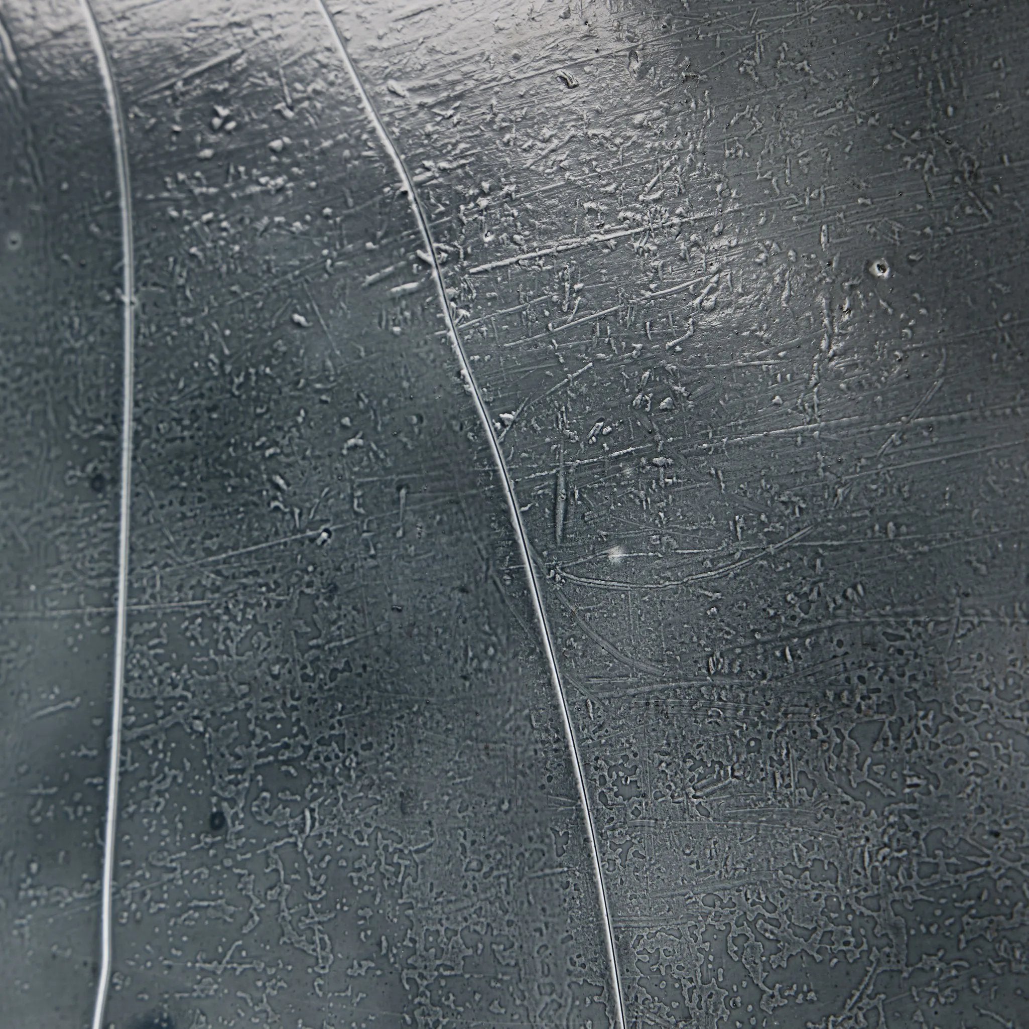 Elevate cocktail hour with an always-in-style rolling bar cart. Crafted from black hammered metal with three tiers of smoked cast glass, offering smooth surface space for storage and display Amethyst Home provides interior design, new home construction design consulting, vintage area rugs, and lighting in the Omaha metro area.