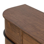 Dark brown walnut is aesthetically shaped with fluid, rounded corners on a ski leg base. The seamless design features six spacious drawers with metal bar hardware that runs along the tops of the drawers Amethyst Home provides interior design, new home construction design consulting, vintage area rugs, and lighting in the Tampa metro area.