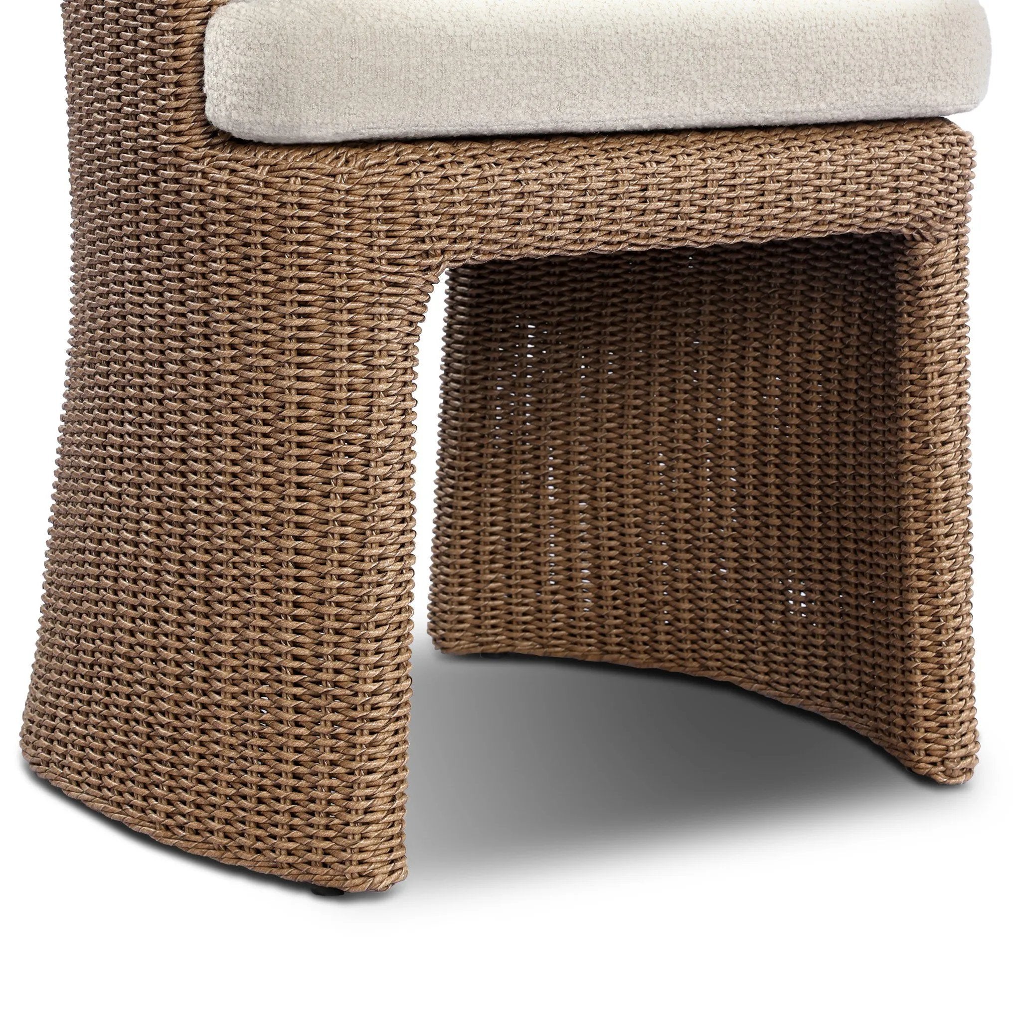 This outdoor dining chair takes on a curved silhouette, crafted from woven faux hyacinth and complemented by a heavily textured boucle cushion. Cover or store inside during inclement weather and when not in use.As lovers of natural materials at Amethyst, we love the designer inspired Thora Outdoor Dining Chair - Vada Cream. Amethyst Home provides interior design, new home construction design consulting, vintage area rugs, and lighting in the Dallas metro area.