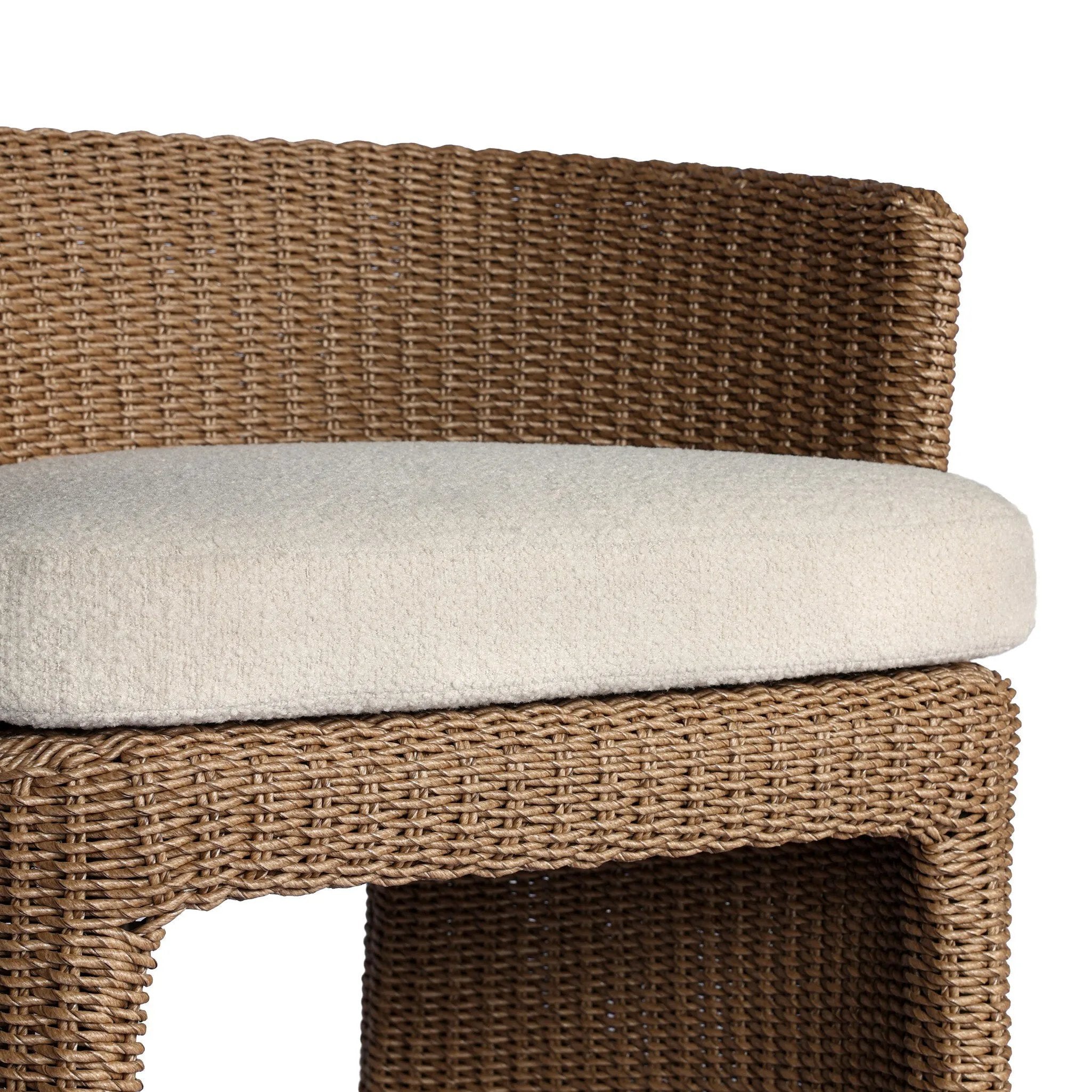 This outdoor dining chair takes on a curved silhouette, crafted from woven faux hyacinth and complemented by a heavily textured boucle cushion. Cover or store inside during inclement weather and when not in use.As lovers of natural materials at Amethyst, we love the designer inspired Thora Outdoor Dining Chair - Vada Cream. Amethyst Home provides interior design, new home construction design consulting, vintage area rugs, and lighting in the Monterey metro area.