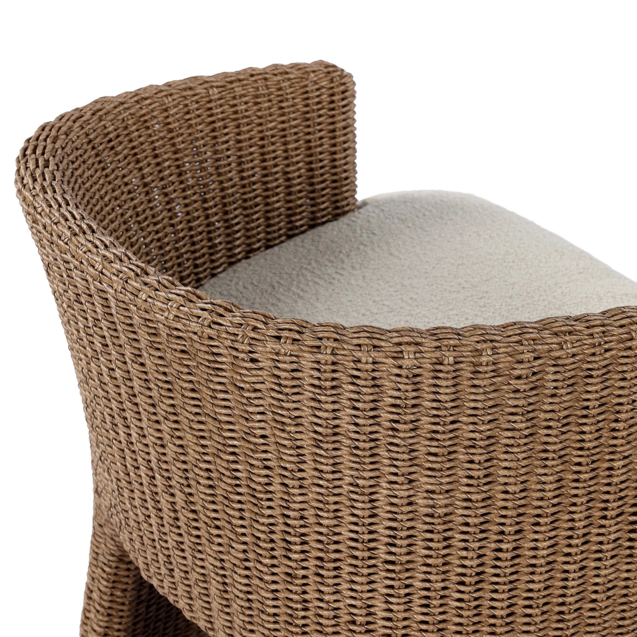 This outdoor dining chair takes on a curved silhouette, crafted from woven faux hyacinth and complemented by a heavily textured boucle cushion. Cover or store inside during inclement weather and when not in use.As lovers of natural materials at Amethyst, we love the designer inspired Thora Outdoor Dining Chair - Vada Cream. Amethyst Home provides interior design, new home construction design consulting, vintage area rugs, and lighting in the Park City metro area.