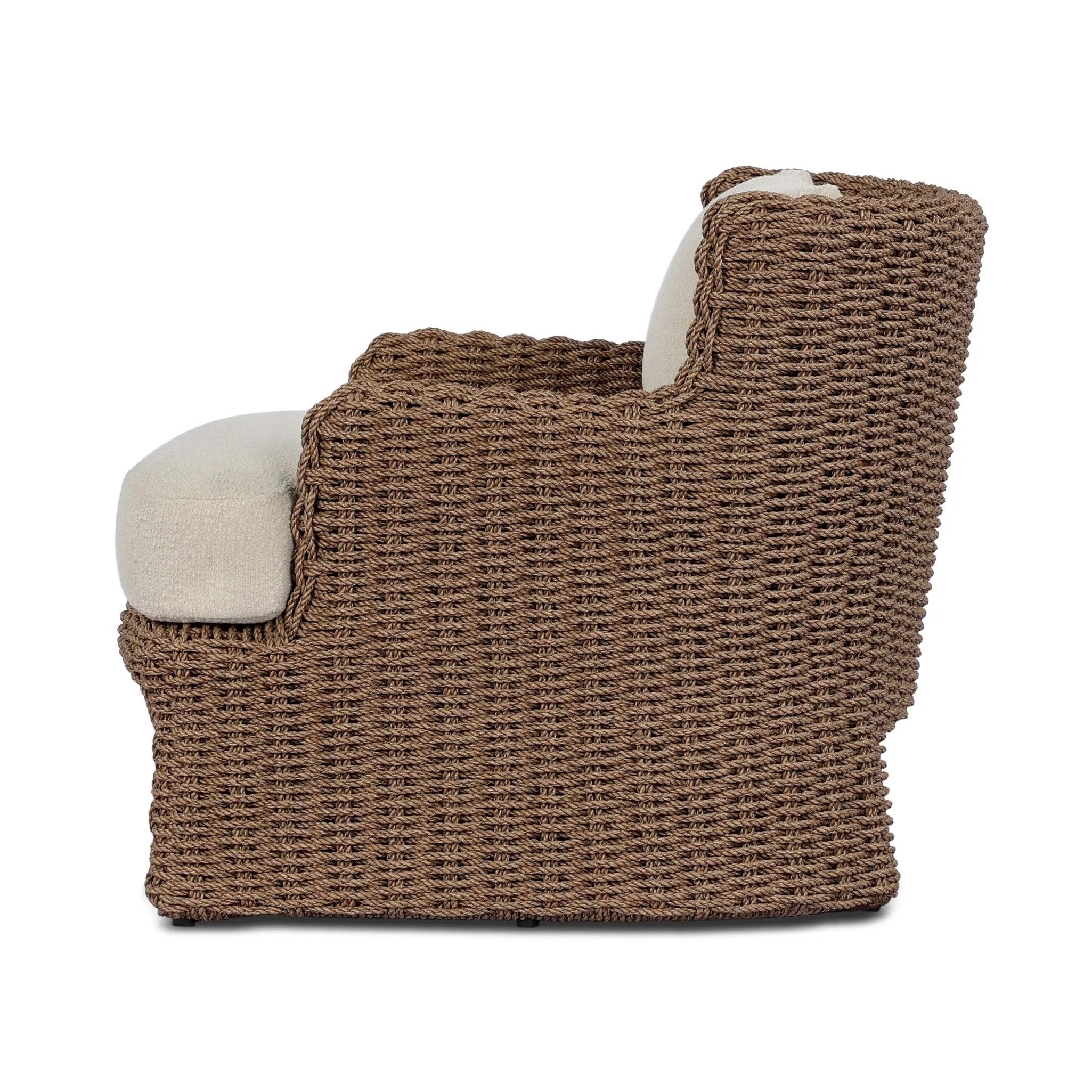 This outdoor chair's sculpted shape mimics classic wingback armchairs, with a double-twist woven material framing heavily textured boucle fabric for added visual weight. Cover or store inside during inclement weather or when not in use. Amethyst Home provides interior design, new home construction design consulting, vintage area rugs, and lighting in the Alpharetta metro area.