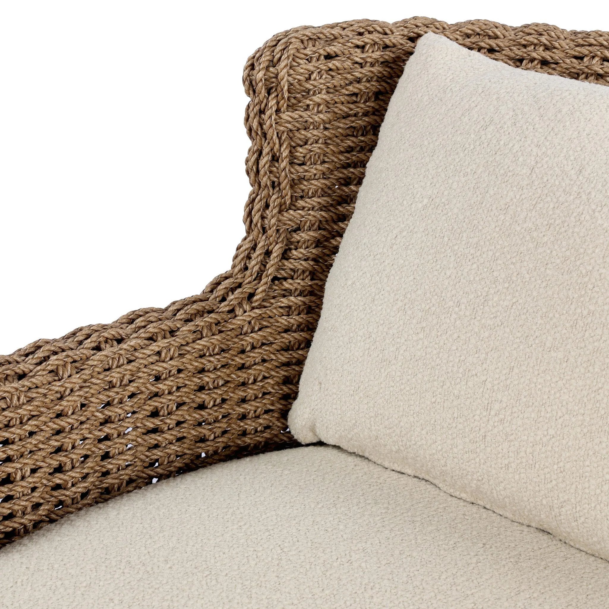 This outdoor chair's sculpted shape mimics classic wingback armchairs, with a double-twist woven material framing heavily textured boucle fabric for added visual weight. Cover or store inside during inclement weather or when not in use. Amethyst Home provides interior design, new home construction design consulting, vintage area rugs, and lighting in the Scottsdale metro area.