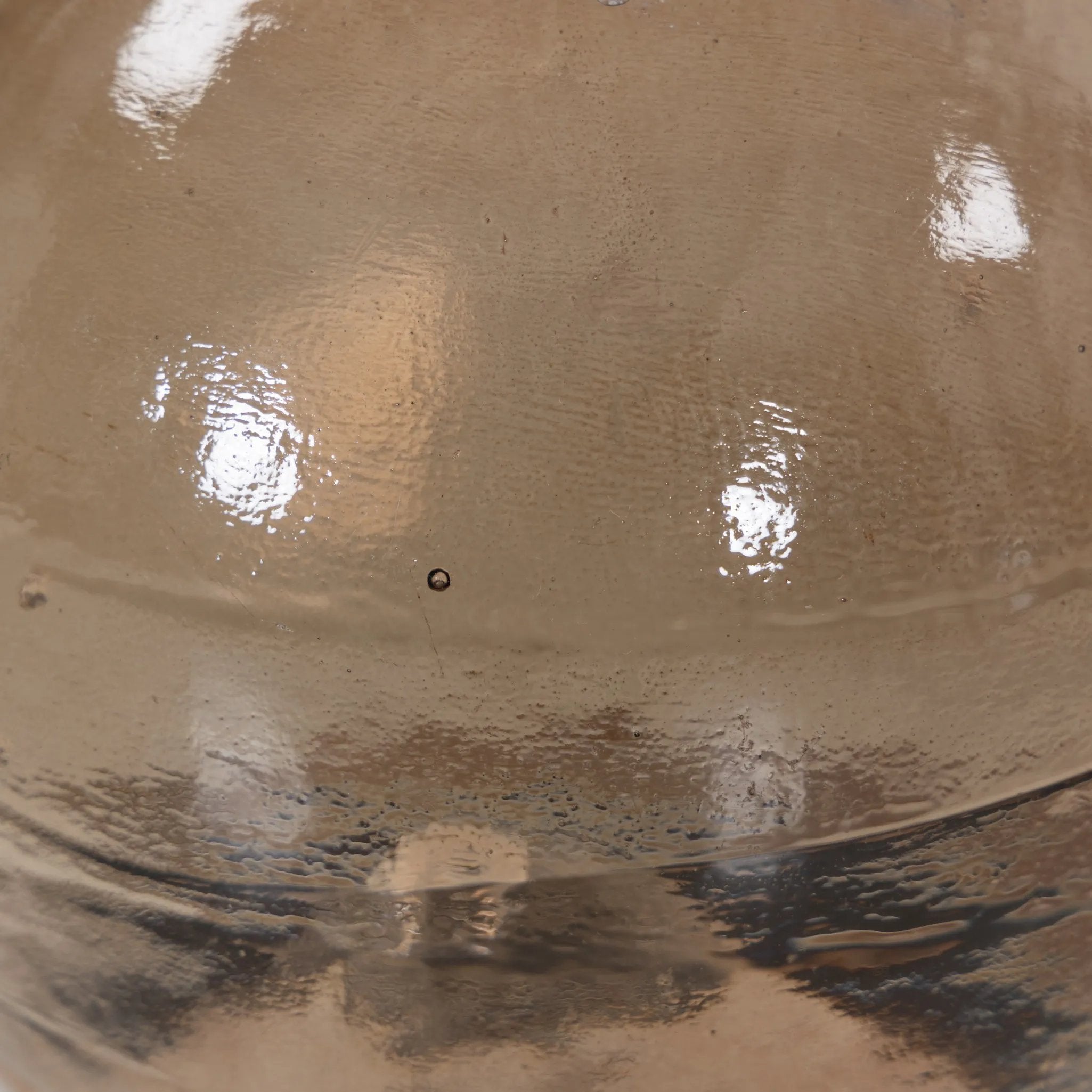 A sphere-shaped base of amber cast glass supports slim, black-finished iron piping and a tray-style tabletop that's perfectly sized to keep your favorite book or nightcap within reach Amethyst Home provides interior design, new home construction design consulting, vintage area rugs, and lighting in the Monterey metro area.