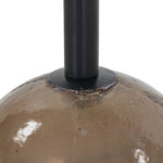 A sphere-shaped base of amber cast glass supports slim, black-finished iron piping and a tray-style tabletop that's perfectly sized to keep your favorite book or nightcap within reach Amethyst Home provides interior design, new home construction design consulting, vintage area rugs, and lighting in the Nashville metro area.