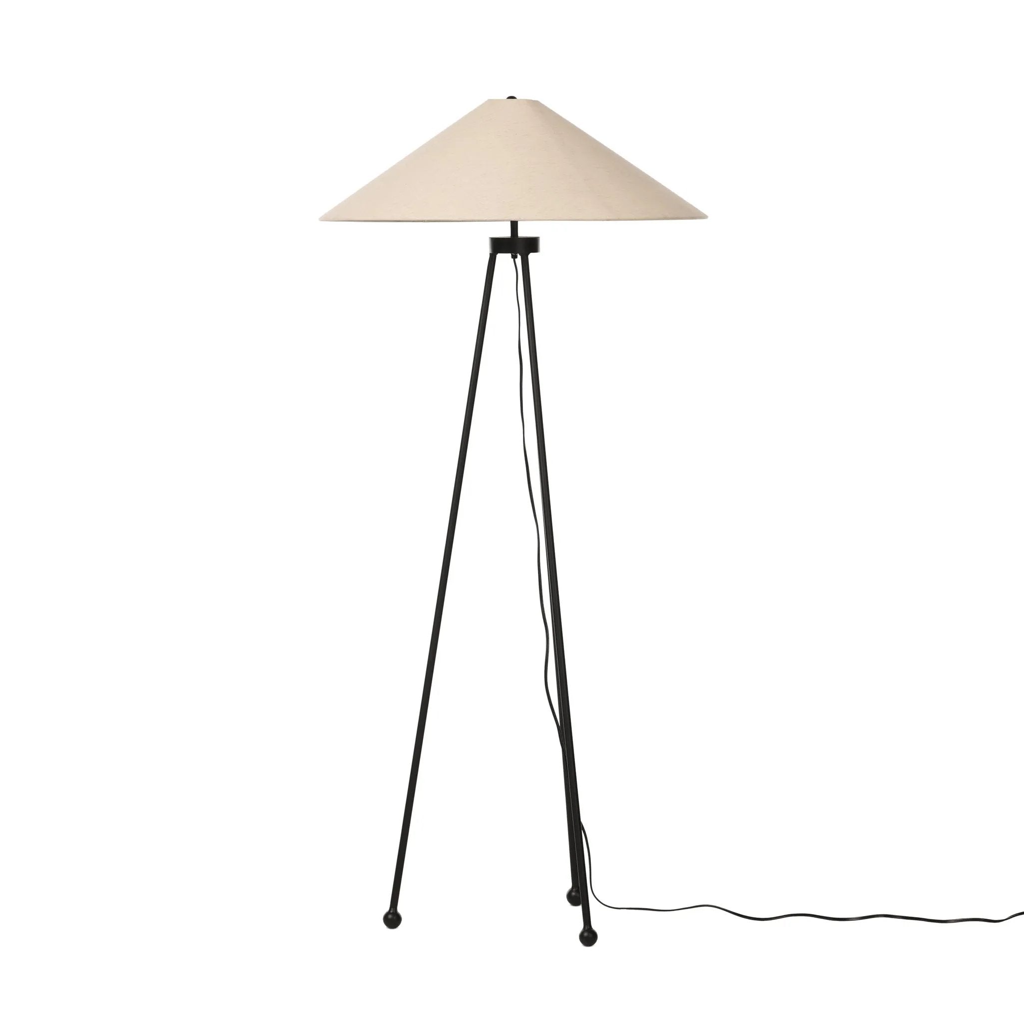 An exaggeratedly slim, airy tripod base of black-finished iron supports a light beige shade of 100% cotton, for a classic look with contrast Amethyst Home provides interior design, new home construction design consulting, vintage area rugs, and lighting in the Boston metro area.